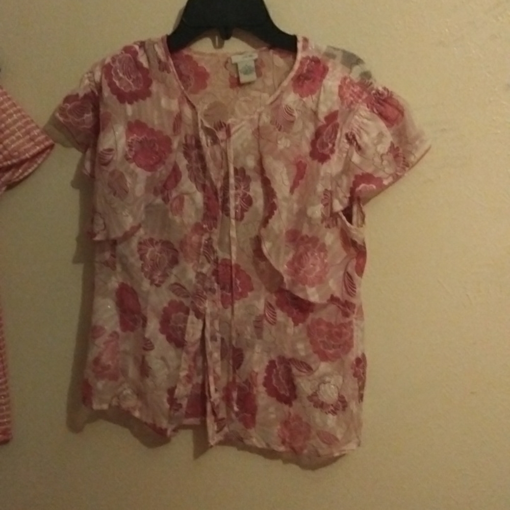 A purple, and white blouse with flowers on it